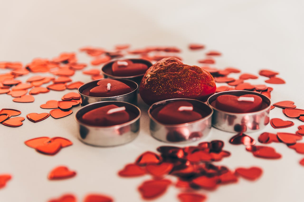 Close up of rose petals and red candle